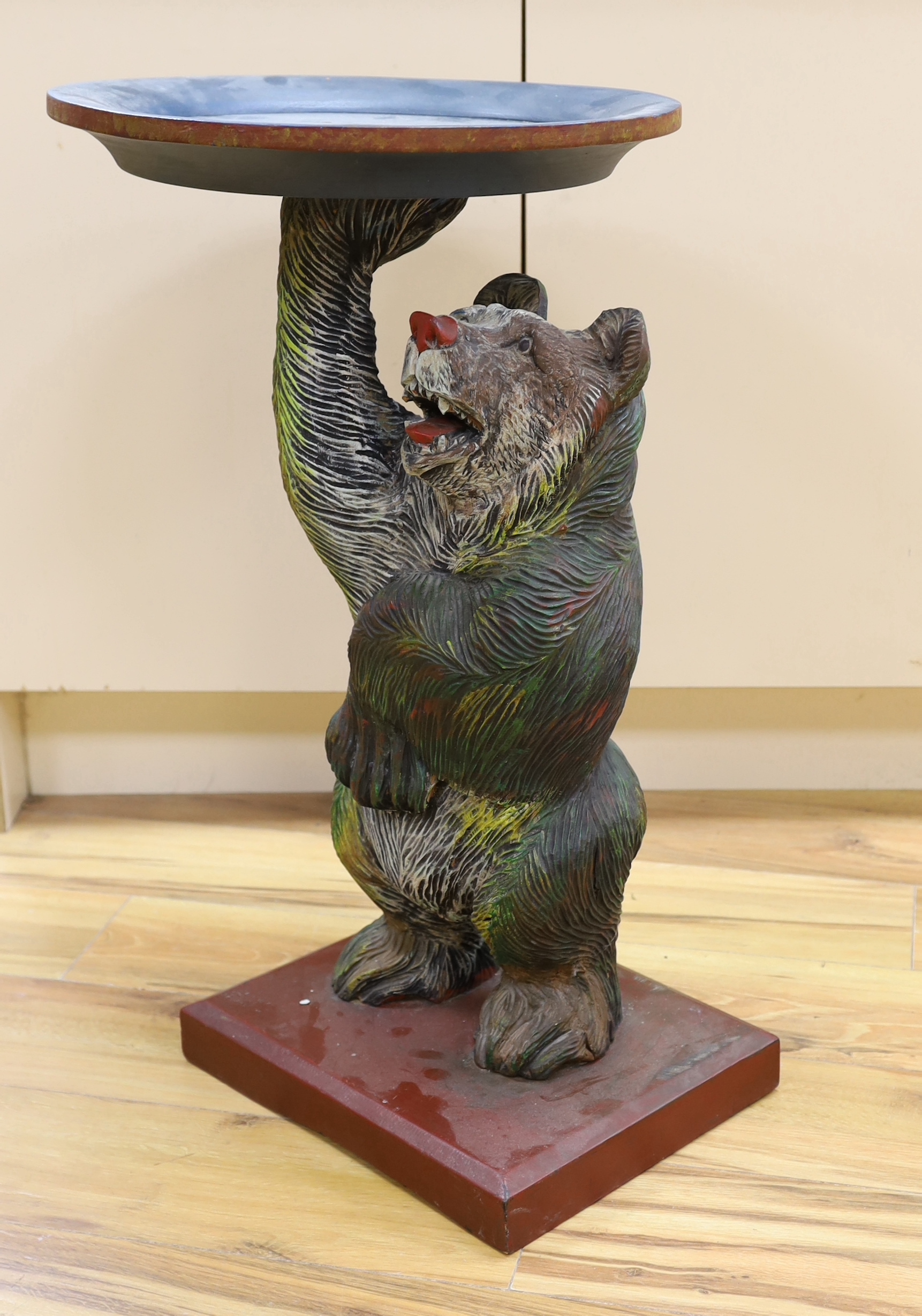 A carved and painted Black Forest bear dumb waiter, 72cm high